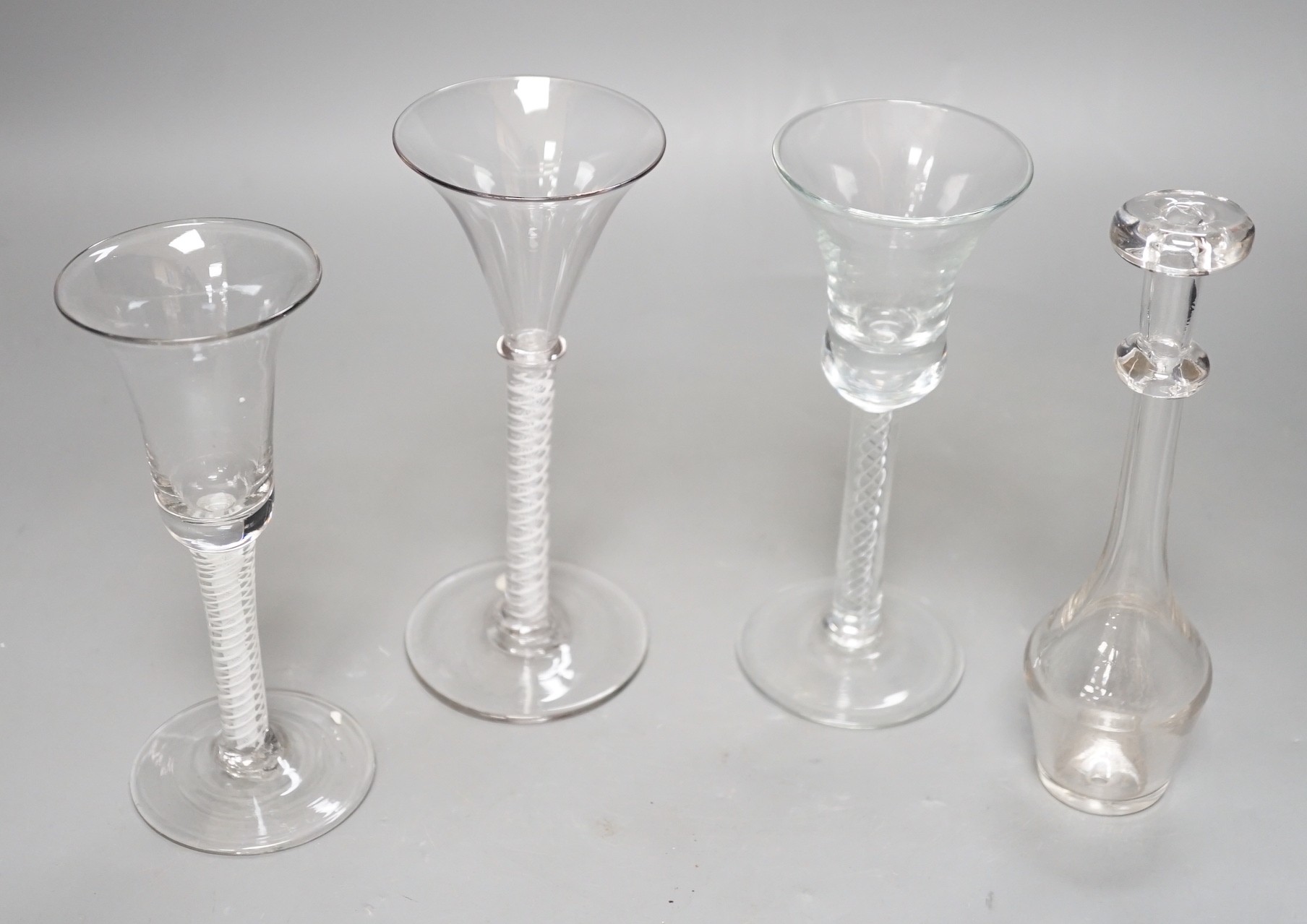 Three opaque or airtwist stem drinking glasses together with a Toddy lifter - 18cm high